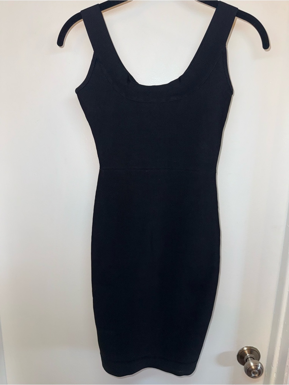 Sleek black BCBGMAXAZRIA fitted bandage dress with a sculpting silhouette.